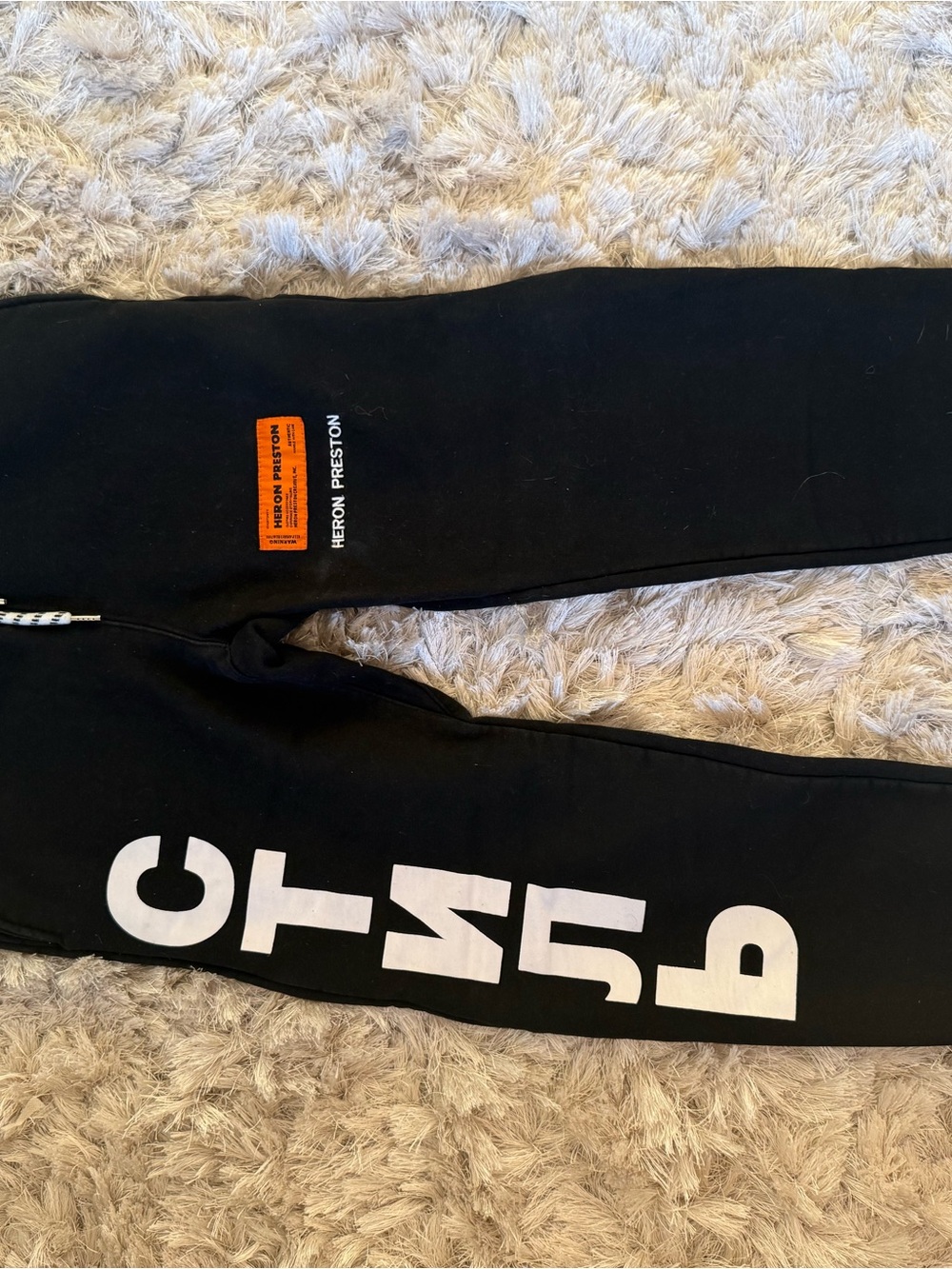 Heron Preston Black Sweatpants with White Lettering and Orange Patch